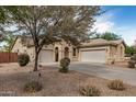 Spacious home featuring a two-car garage, desert landscaping, and a well-maintained exterior at 2112 E Yellowstone Pl Pl, Chandler, AZ 85249
