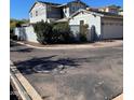 Exterior angle of home, featuring a partial view of a balcony and a detached two-car garage at 21134 W Green St, Buckeye, AZ 85396