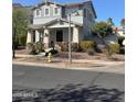 Inviting home with a covered porch, landscaped flower beds, and a well-manicured front yard at 21134 W Green St, Buckeye, AZ 85396