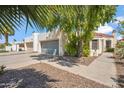 Lovely home featuring a gray garage door, desert landscaping, and a paved walkway to the entrance at 2170 E Alameda Dr, Tempe, AZ 85282