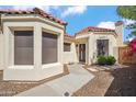 Close-up of exterior elevation featuring a modern front door with a festive wreath, and desert landscaping at 2170 E Alameda Dr, Tempe, AZ 85282