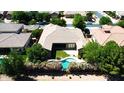 Stunning aerial view of backyard showcasing pool, lush landscaping, and meticulously maintained lawn of a single-Gathering home at 22290 E Escalante Rd, Queen Creek, AZ 85142