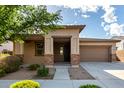 Inviting single-story home featuring a well-maintained front yard and a welcoming covered porch at 23195 S 226Th Way, Queen Creek, AZ 85142