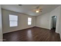 Open concept living room with ceiling fan and hard surface floors at 23424 W Pima St, Buckeye, AZ 85326