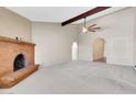 Large living room featuring a brick fireplace, decorative arches and neutral colored carpet at 2346 E Jasmine St, Mesa, AZ 85213