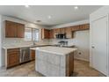 Kitchen featuring stainless steel appliances, a large island, modern countertops, and ample cabinet space at 2408 W Saint Kateri Dr, Phoenix, AZ 85041