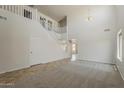 Living room showcasing soaring ceilings, a staircase with white railing, and a view into the dining room at 2408 W Saint Kateri Dr, Phoenix, AZ 85041
