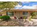 Inviting front entrance with a well-maintained walkway, colorful potted plants, and decorative stones at 2920 W Michigan Ave, Phoenix, AZ 85053