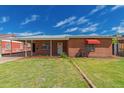 Charming brick home with a well-maintained lawn and covered parking at 2936 E Willetta St, Phoenix, AZ 85008