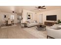 Bright and airy living room featuring a ceiling fan, plush seating, and modern decor for comfortable living at 2936 E Willetta St, Phoenix, AZ 85008