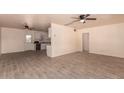 Open concept living area with a ceiling fan, easy access to the kitchen, and tile floors at 2936 E Willetta St, Phoenix, AZ 85008