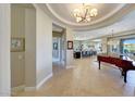Grand entryway with a tray ceiling, tile floors, and an adjacent formal living and dining area at 29749 N 130Th Dr, Peoria, AZ 85383