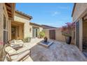 Private courtyard featuring travertine tile, a water feature, and comfortable seating, perfect for relaxation at 29749 N 130Th Dr, Peoria, AZ 85383