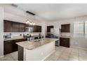 Charming kitchen with stainless steel appliances, granite counters and tile floors for a clean and modern look at 29809 W Columbus Ave, Buckeye, AZ 85396