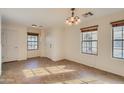Open-concept living room with tile flooring, neutral paint, and ample natural light at 2994 E Megan St, Gilbert, AZ 85295