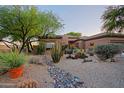 Beautiful single-story house with desert landscaping, rock features, and a well-maintained yard at 32472 N 68Th Pl, Scottsdale, AZ 85266