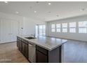 Spacious kitchen island with stainless steel appliances and dark cabinetry, open floor plan at 35524 N Tin Ct, San Tan Valley, AZ 85144