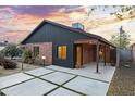 Charming single-story home with red brick and modern siding, well-manicured yard, and a concrete driveway with grass accents at 358 E Whitton Ave, Phoenix, AZ 85012