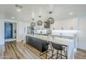 Bright kitchen features a large island with bar seating, modern appliances, and stylish pendant lighting at 36601 N Mule Train Rd # D1, Carefree, AZ 85377