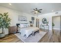 Airy main bedroom with wood-look floors, ceiling fan, an ensuite bathroom, and lots of natural light at 36601 N Mule Train Rd # D1, Carefree, AZ 85377