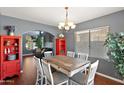 Bright dining room with a rustic table, archway access, and views of the living room beyond at 3679 S Cottonwood Ct, Chandler, AZ 85286
