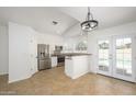 Well-lit kitchen features stainless steel appliances, white cabinets, and access to the pool area at 3755 E Broadway Rd # 21, Mesa, AZ 85206