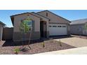 Charming single-story home featuring a two-car garage and professionally landscaped front yard at 5537 S 246Th Ave, Buckeye, AZ 85326