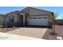 Charming single-story home featuring a two-car garage and professionally landscaped front yard at 5537 S 246Th Ave, Buckeye, AZ 85326