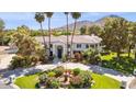 Expansive estate featuring circular driveway, mature landscaping, water feature, and mountain views at 6467 E Sierra Vista Dr, Paradise Valley, AZ 85253