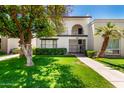 Charming two-story condo featuring a gated entry, balcony, and lush landscaping at 7684 E Minnezona Ave, Scottsdale, AZ 85251