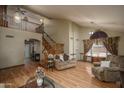 Spacious living room with hardwood floors, high ceilings, a staircase, and lots of natural light at 8469 W Emile Zola Ave, Peoria, AZ 85381