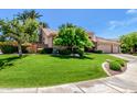 Expansive front lawn and lush landscaping complement this beautiful property, enhanced by mature shade trees at 9571 N 117Th St, Scottsdale, AZ 85259