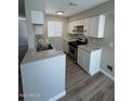 Newly remodeled kitchen featuring white cabinets, modern countertops, and stainless steel oven at 97 N Cooper Rd # 97, Chandler, AZ 85225