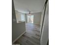 Bright living room with ceiling fan, modern flooring, and sliding doors to patio at 97 N Cooper Rd # 97, Chandler, AZ 85225
