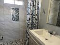 Bathroom with tiled shower, decorative shower curtain and modern fixtures at 9913 E Main St # 40, Mesa, AZ 85207