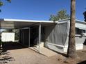 Exterior view of the mobile home, with covered patio and storage shed in the back at 9913 E Main St # 40, Mesa, AZ 85207