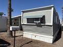 Exterior view of gray mobile home with unit number and exterior air conditioning unit at 9913 E Main St # 40, Mesa, AZ 85207
