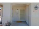 Covered front porch showcasing the home's address, updated light fixture, and secured screen door at 1125 E Milada Dr, Phoenix, AZ 85042