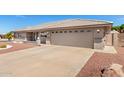A long driveway leading up to a two-car garage, complemented by desert landscaping at 11510 E Lomita Ave, Mesa, AZ 85209