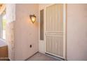 Inviting front entrance with a security screen door, light fixture, and a view of the front yard at 1343 W Roadrunner Dr, Chandler, AZ 85286