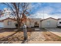 Charming single-story home features a unique stone pathway, mailbox and a welcoming arched entryway at 1602 N 73Rd Ave, Phoenix, AZ 85035