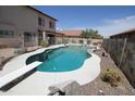 A backyard pool with diving board, waterfall feature, spa, and decorative rock at 16233 N 32Nd Ave, Phoenix, AZ 85053