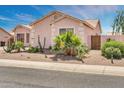 A single-story home featuring desert landscaping and a quaint gate at 1633 E Jasmine St, Casa Grande, AZ 85122