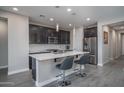 Bright kitchen featuring a central island with bar seating, stainless steel appliances, and stylish pendant lighting at 16500 W Caldwell St, Goodyear, AZ 85338