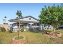 Charming single-story home featuring lush green lawn and mature trees enhancing its curb appeal in daylight at 1657 N 55Th Ave, Phoenix, AZ 85035