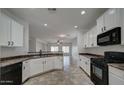 Modern kitchen with white cabinets, stainless steel appliances, and a breakfast bar at 171 W Hawaii Dr, Casa Grande, AZ 85122