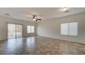 Spacious living room with tile floors, ceiling fan, and ample natural light from the windows at 171 W Hawaii Dr, Casa Grande, AZ 85122