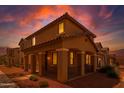 Inviting two-story home featuring a covered porch with stylish columns during a colorful dusk at 17878 N 114Th Ln, Surprise, AZ 85378