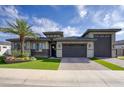 Inviting single-Gathering home with a desert landscape, artificial lawn, and two-car garage under a blue sky at 18175 W Highland Ave, Goodyear, AZ 85395