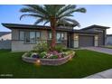 Well-kept home with desert landscaping and lighting, with a neat artificial lawn at 18175 W Highland Ave, Goodyear, AZ 85395